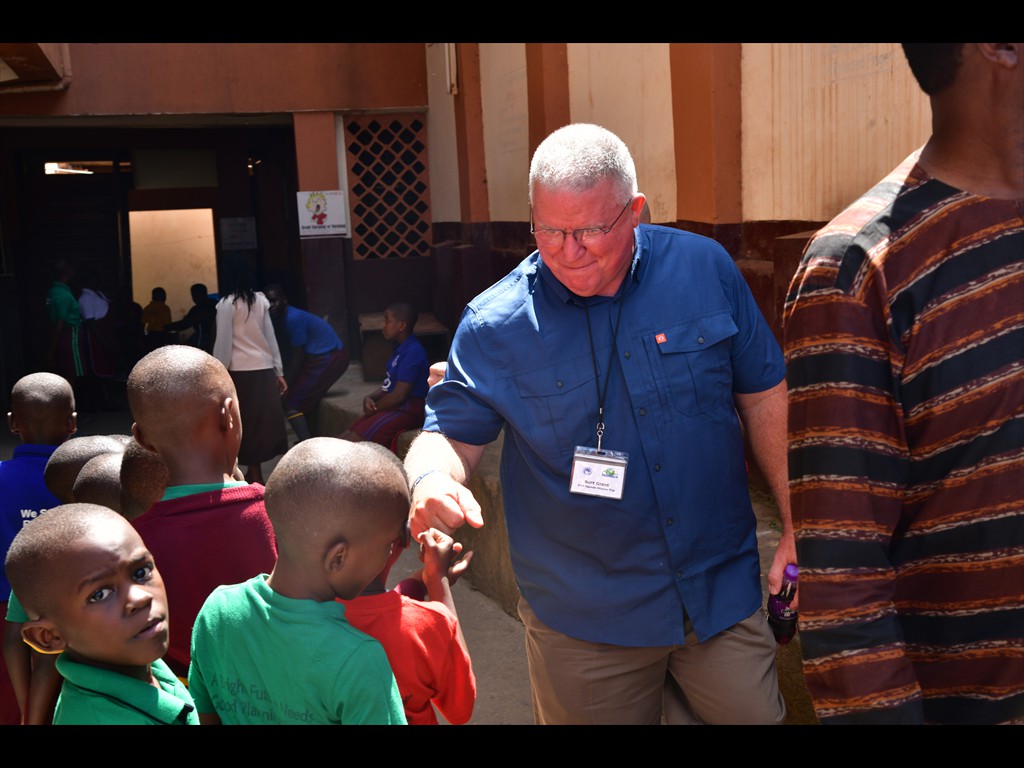Bart Grant giving knuckle bumps with the children