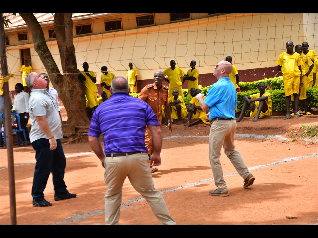 Pastor Joel, Bart Grant and Joey Brown playing volleyball with prisoners