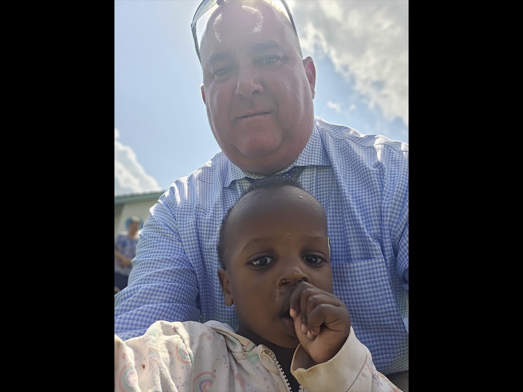 Pastor Joel with little girl at Nairobi Children's Rescue Center