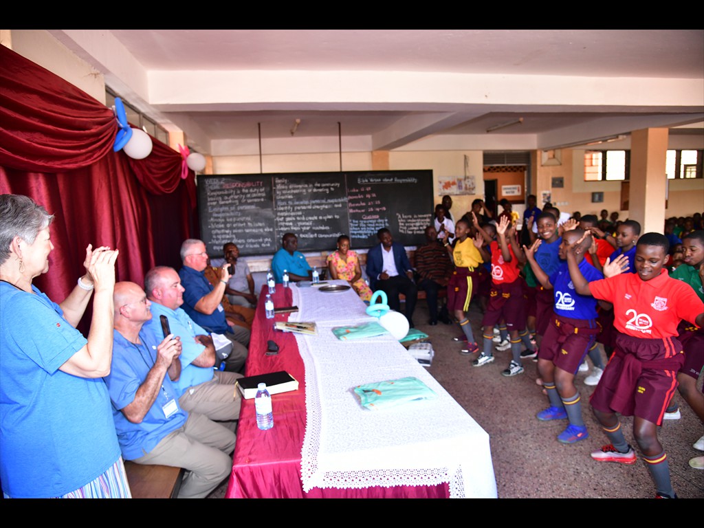 School children perform for the mission team